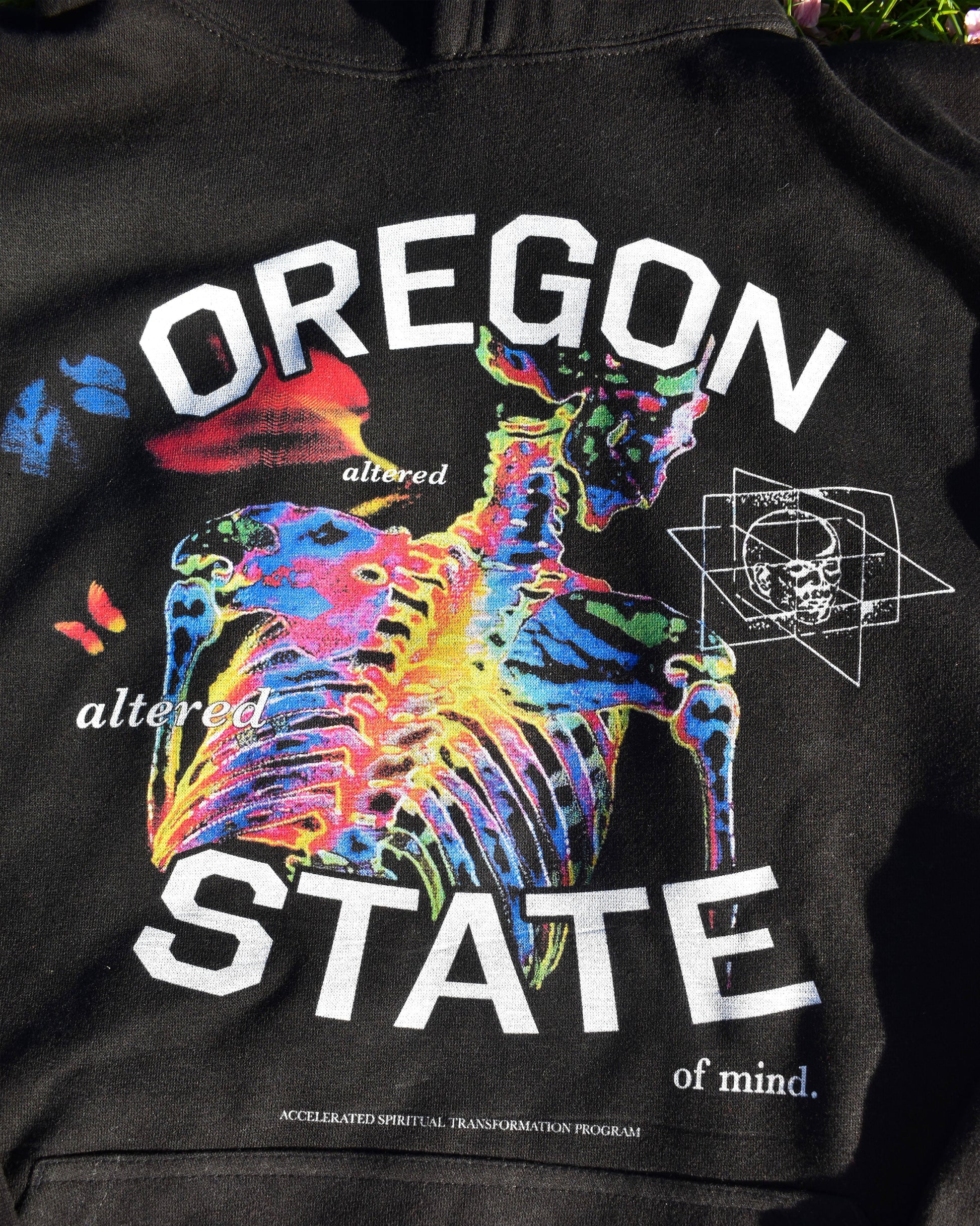 Close-up of black Oregon State of Mind hoodie with colorful psychedelic skeleton graphic